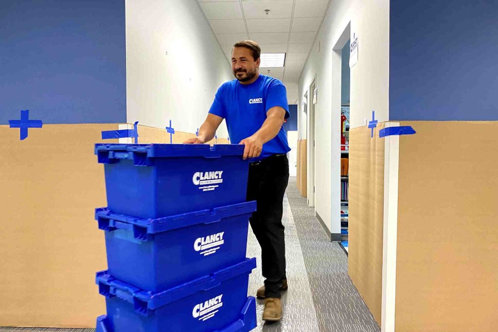Men pushing containers
