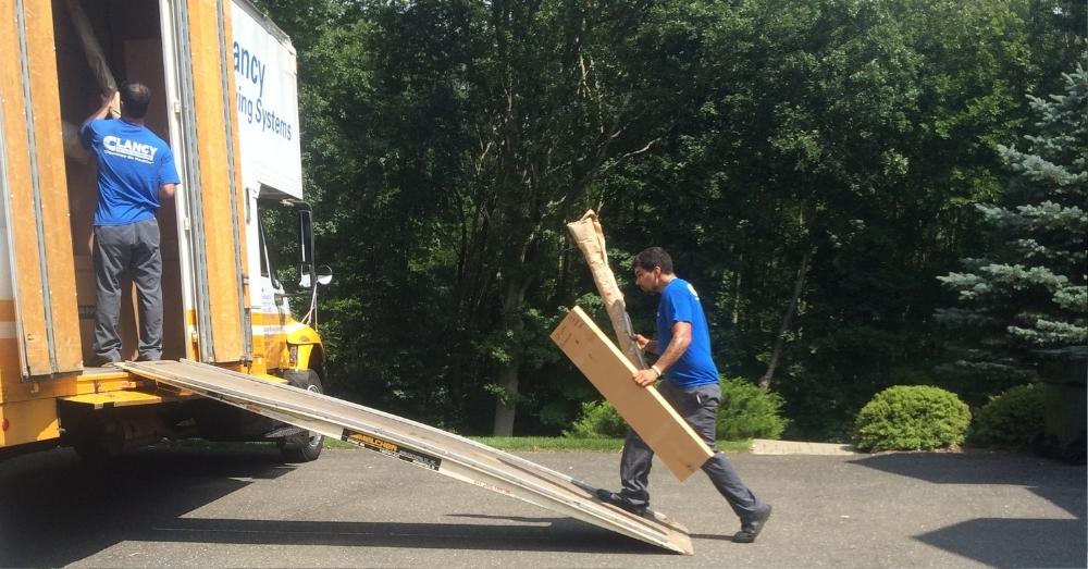 mover walking on a ramp to store packages