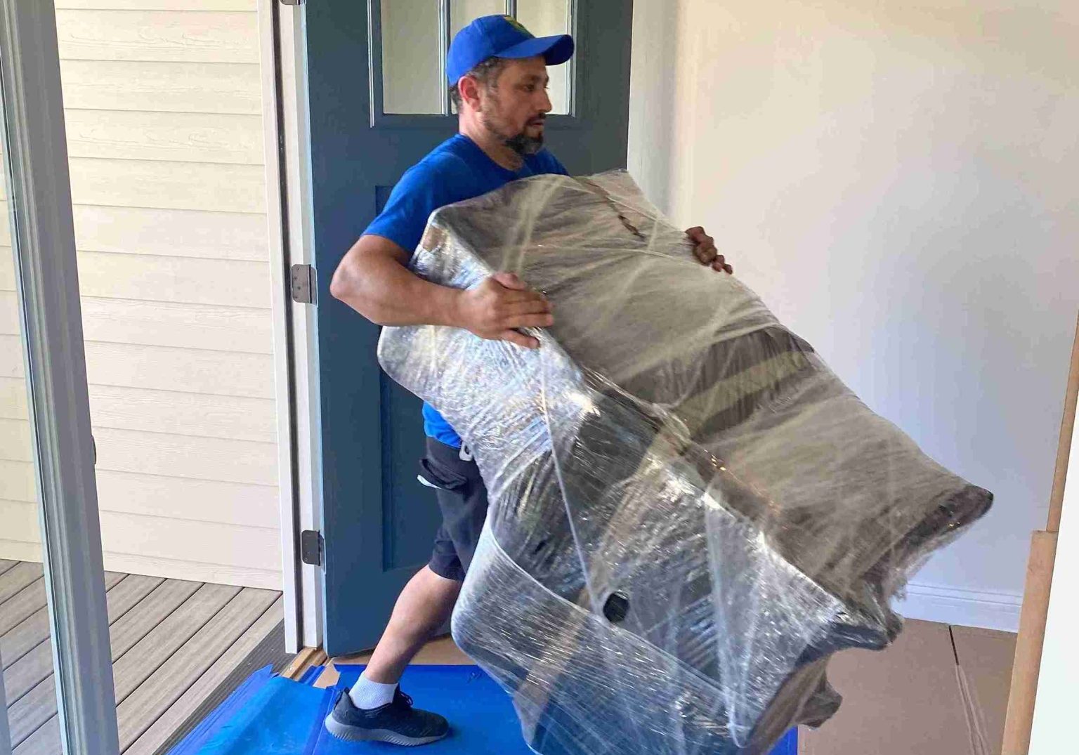 person carrying the wrapped chair