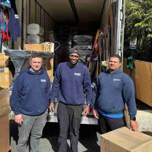 movers team standing behind the moving truck