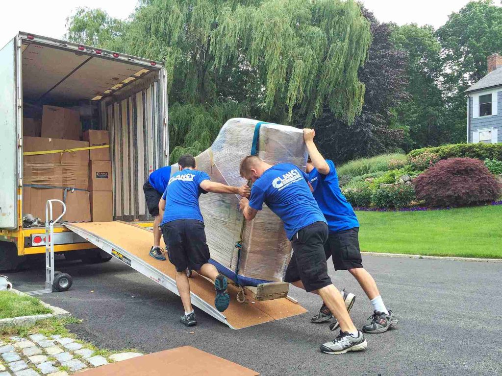 moving team pushing a piano to the truck
