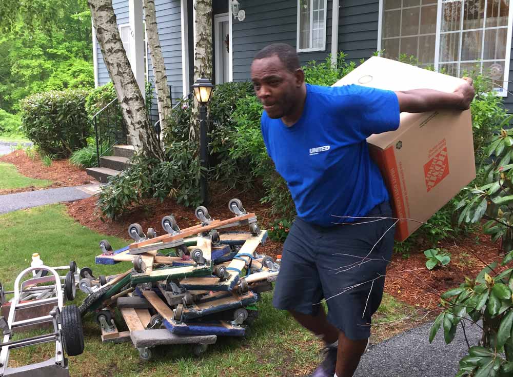 Professional Mover Transporting Boxes